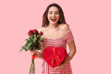 Beautiful young woman with gift and flowers on color background. Valentine's Day celebration