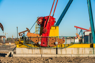 Oil pumps are running in the sunset at the oil field. On the Bohai coast of China
