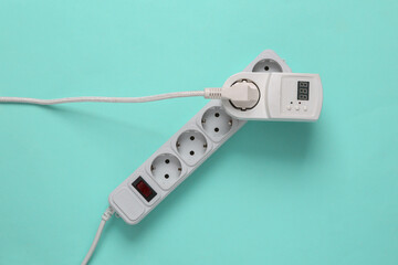 Electrical Extension cord and socket with fuse and electrical plug on blue background