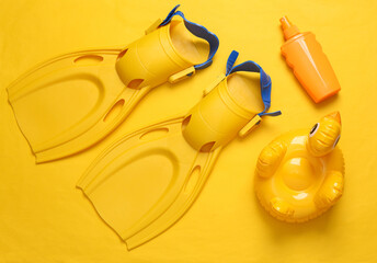 Beach accessories on a yellow background. Top view. Flat lay