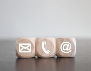Contact Methods. Close-up of a phone, email and post icons wooden block.