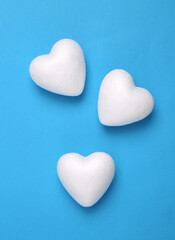 Three white hearts on blue background
