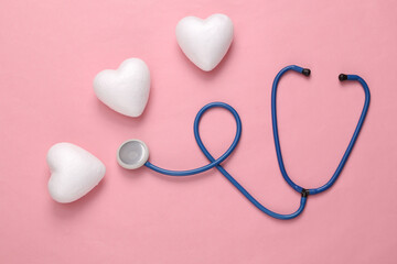 Stethoscope with hearts on a pink background. Medicine, love concept