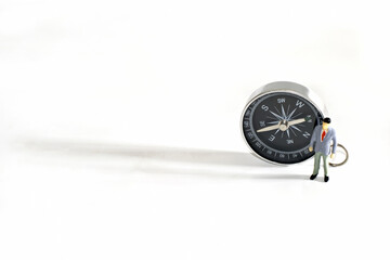 Businessman Figure miniature or small people ,compass and shadow on white background.