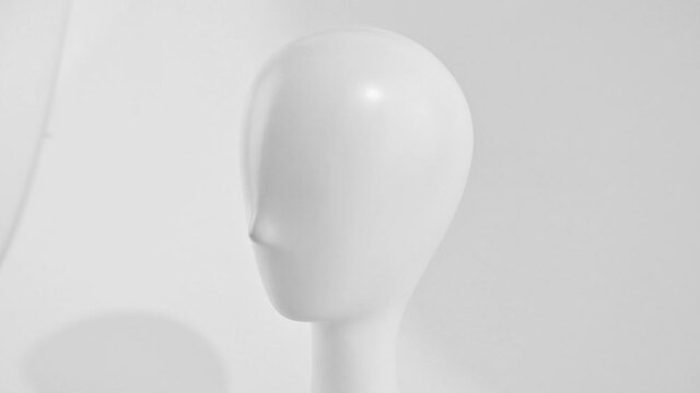 Overview of a white mannequin head of a human. Plastic mannequin of a human head isolated on a white background.