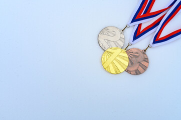 Gold, silver and bronze medal with winter nature in background. Sport trophy concept photo for winter game in China