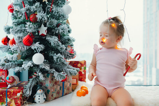 happy new year and christmas indoor photo - cute baby and mother with spruce tree and toys