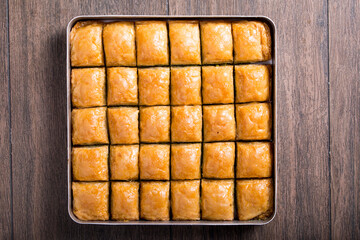baklava with walnuts in tray
onthe wooden table