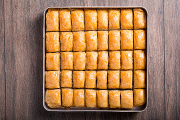 baklava with walnuts in tray
onthe wooden table