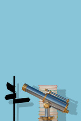 Cover page with an old antique metal telescope standing near a stack of books with a post showing directions at solid blue background with copy space and shadow. Concept exploration, education travel.