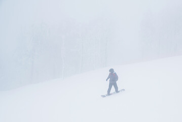 Skier silhouette in winter white mist