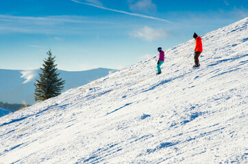 Naklejka na ściany i meble Skier have fun in mountains, beautiful sunset light in background. Ski resort, winter sport