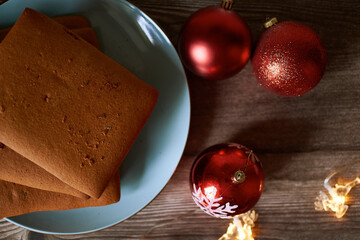 Gingerbread cookies new year Christmas, beautiful gingerbread on a blue plate with Christmas balls and garland with deer