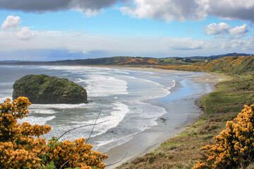 shoreline of southern chile with waves coming into the bay