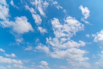 Naklejka na ściany i meble Blue sky and white fluffy tiny clouds background and pattern