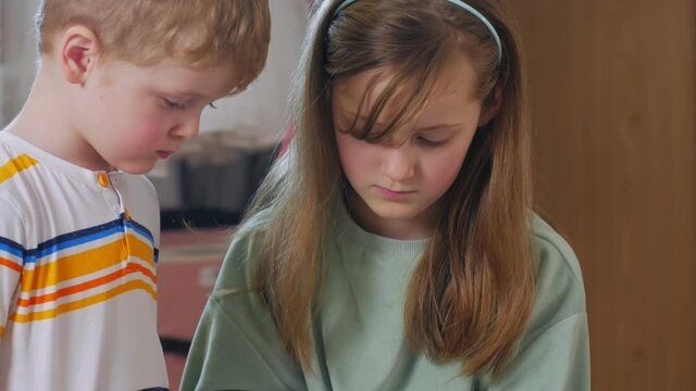 Brother and sister with tablet close up