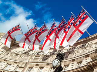 White Ensign flag of the Royal Navy flying from Admiralty Arch in London England UK which is a popular tourist holiday travel destination and attraction landmark, stock photo image