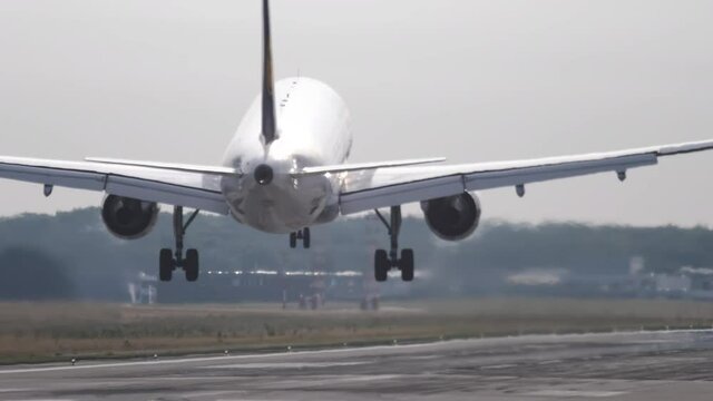 Airplane approaching and landing at early morning. Airplane arrival. Aviation and travel concept
