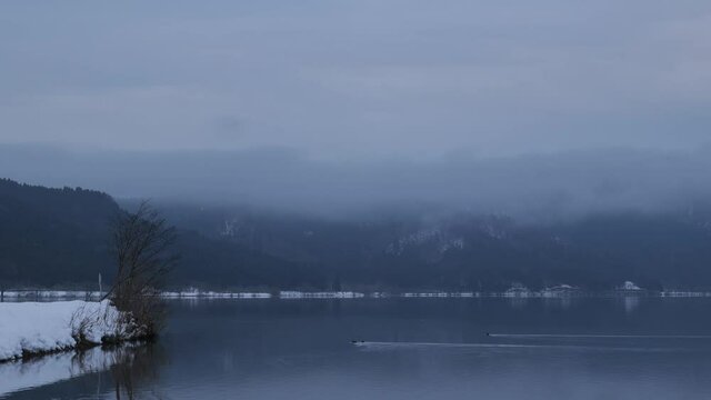 Video of Lake Yogo, Shiga Prefecture, in the dead of winter, with the surrounding area covered in white snow, a frozen landscape.