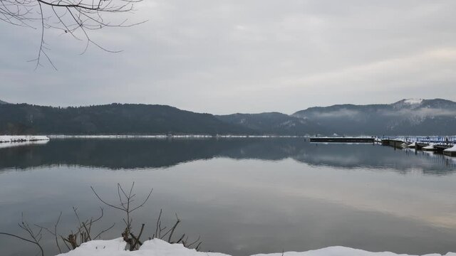 Video of Lake Yogo, Shiga Prefecture, in the dead of winter, with the surrounding area covered in white snow, a frozen landscape.