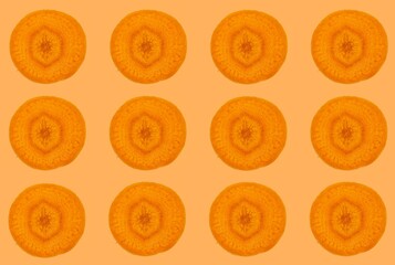Carrot slices pattern, top view of carrot slices isolated on orange background.