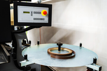 Machine for applying edging to chipboard panels. Equipment for a small furniture factory. Close-up
