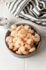 Thawed peeled shrimp, seafood, delicacy. on a white background, in a dish. beautiful product presentation