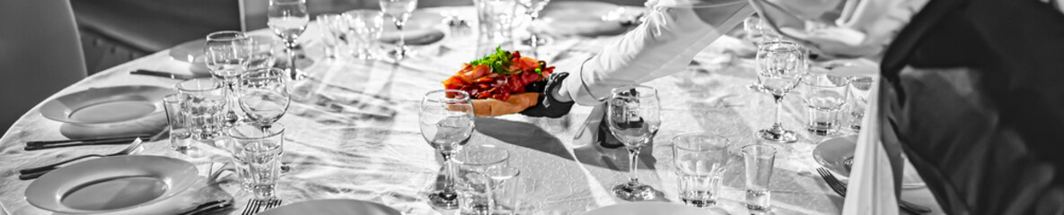 woman hands of a waiter prepare food for a buffet table in a restaurant