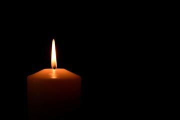 burning candles close-up on black background