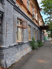 Fototapeta na wymiar Shuttered windows in an old stone house