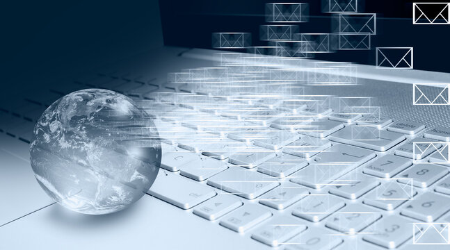 Laptop computer keyboard with email icon -  Close up of female blured hands typing on laptop keyboard - Glass globe on laptop keyboard "Elements of this image furnished by NASA "