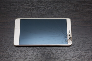 Modern mobile smartphone with broken screen.