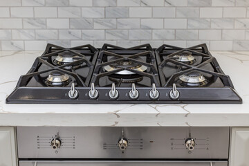 Modern gas stove built into the kitchen furniture.