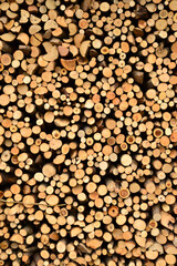 Outdoor stacked dry wood, wood cross section, natural textured background
