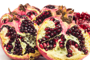 Garnet fruits cut on two isolated on white background. Halves of pomegranate fruits close up. Fresh, ripe garnets. Tropical, citrus fruits. Healthy, vitamin food