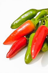 Red and green chilies, against white background, close-up