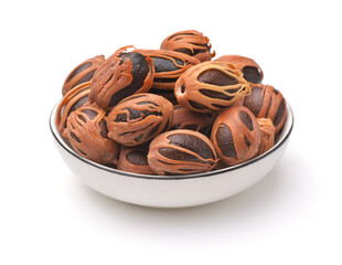 Whole nutmegs with mace in ceramic bowl