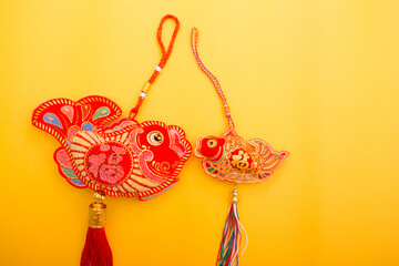 Lunar New Year decoration with lucky gold bar, lucky sacks, and red fish isolated on yellow . Tet...