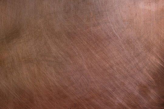 Texture of copper sheet. Copper background. Lighting on the right. Indoor. 