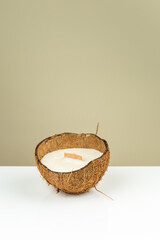 Decorative wax candle in a coconut shell