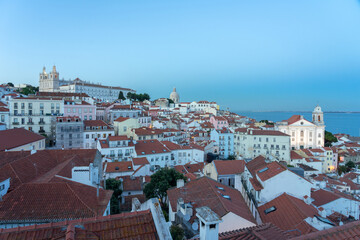 Panoramic view of the Alfama historic neighborhood of Lisbon illuminated at night from Portas do Sol viewpoint. Portugal.