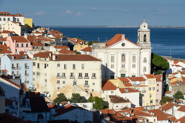 Panoramic view of the Alfama historic neighborhood of Lisbon at sunset from Portas do Sol viewpoint. Portugal.