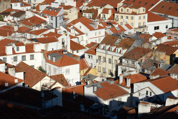 Panoramic view of the Alfama historic neighborhood of Lisbon at sunset from Portas do Sol viewpoint. Portugal.