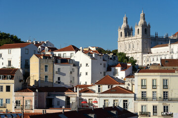 Fototapeta premium Panoramic view of the Alfama historic neighborhood of Lisbon at sunset from Portas do Sol viewpoint. Portugal.