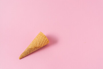Ice cream cone on a light pink background.