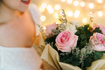Happy Asian beautiful young woman holding a bouquet of flowers in wedding ceremony. 
