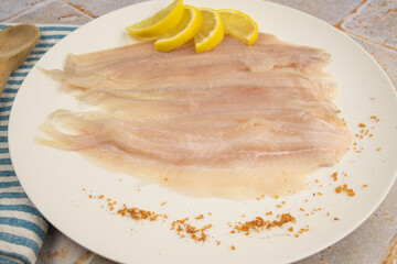 raw flounder fillet in a plate	