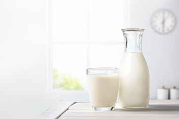 Fresh milk on wooden table in kitchen room.