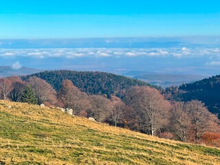 View of the Alsace plain from the Petit Ballon summit on a sunny winter day, with clouds below