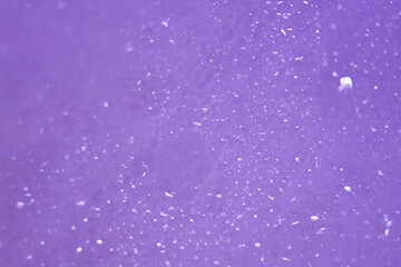 Background is purple with a bokeh effect. Blur effect. Effect of soap bubbles. 